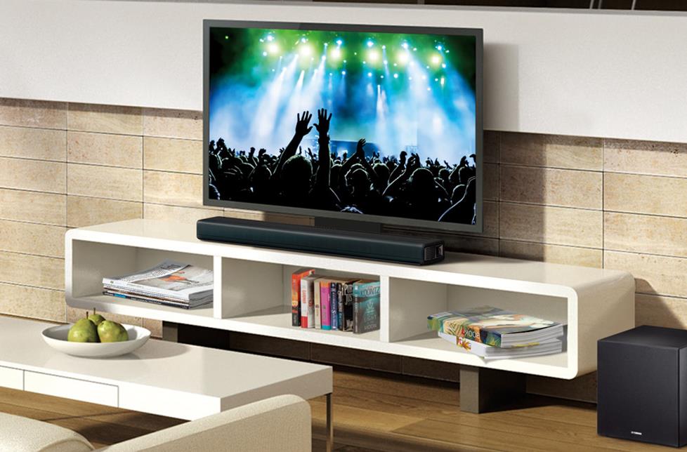 Sound bar resting on a TV stand