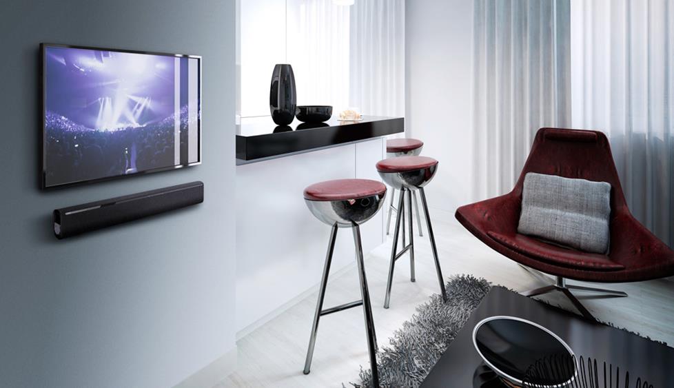Sound bar mounted under TV on wall
