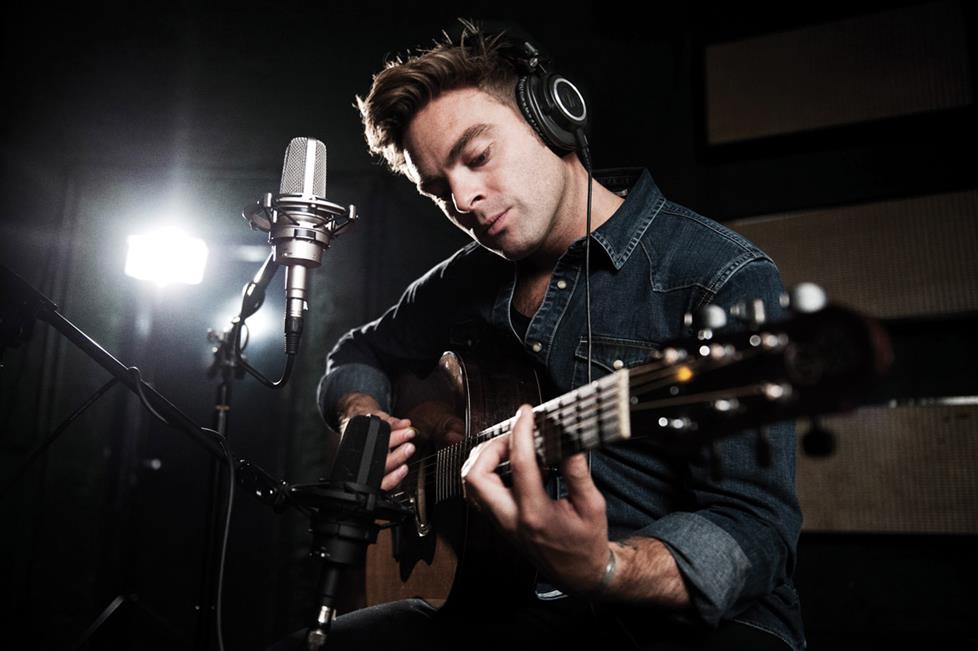 Musician recording guitar and vocals