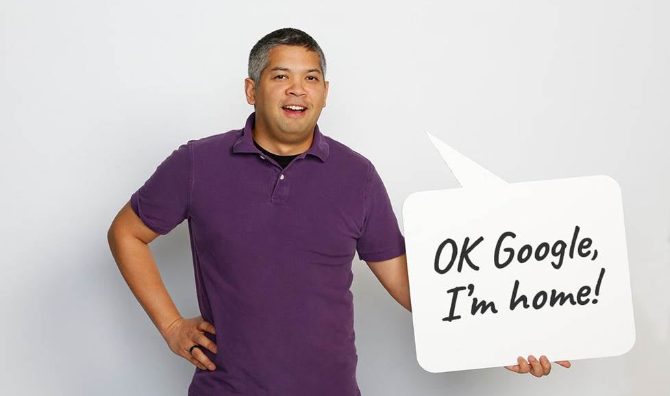 Man holding speech bubble that says "OK Google, I'm home"