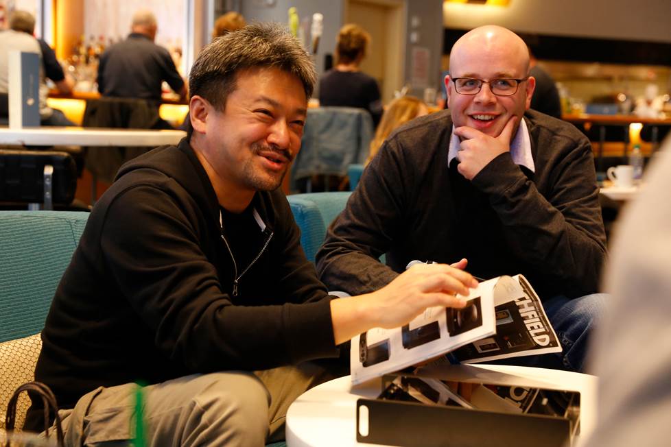 Jeffrey Miller and Tomoaki Sato looking at an old Crutchfield catalog