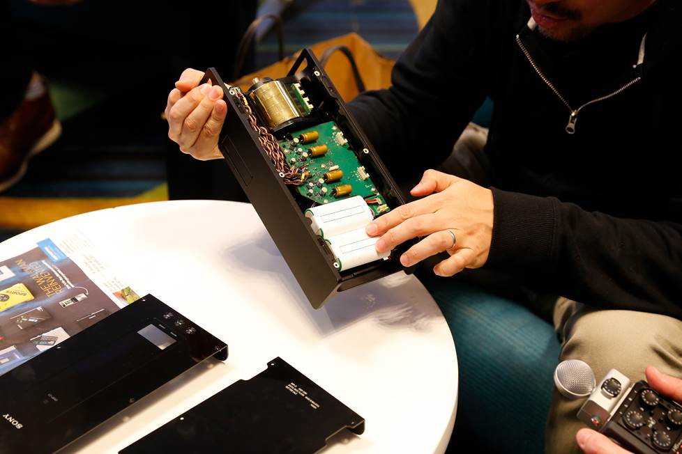 Tomoaki Sato pointing to the power supply on the DMPZ1