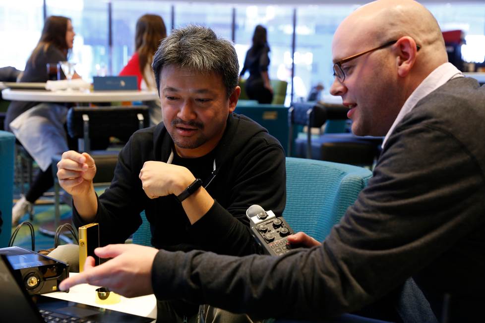 Jeffrey Miller and Tomoaki Sato in a restaurant chatting
