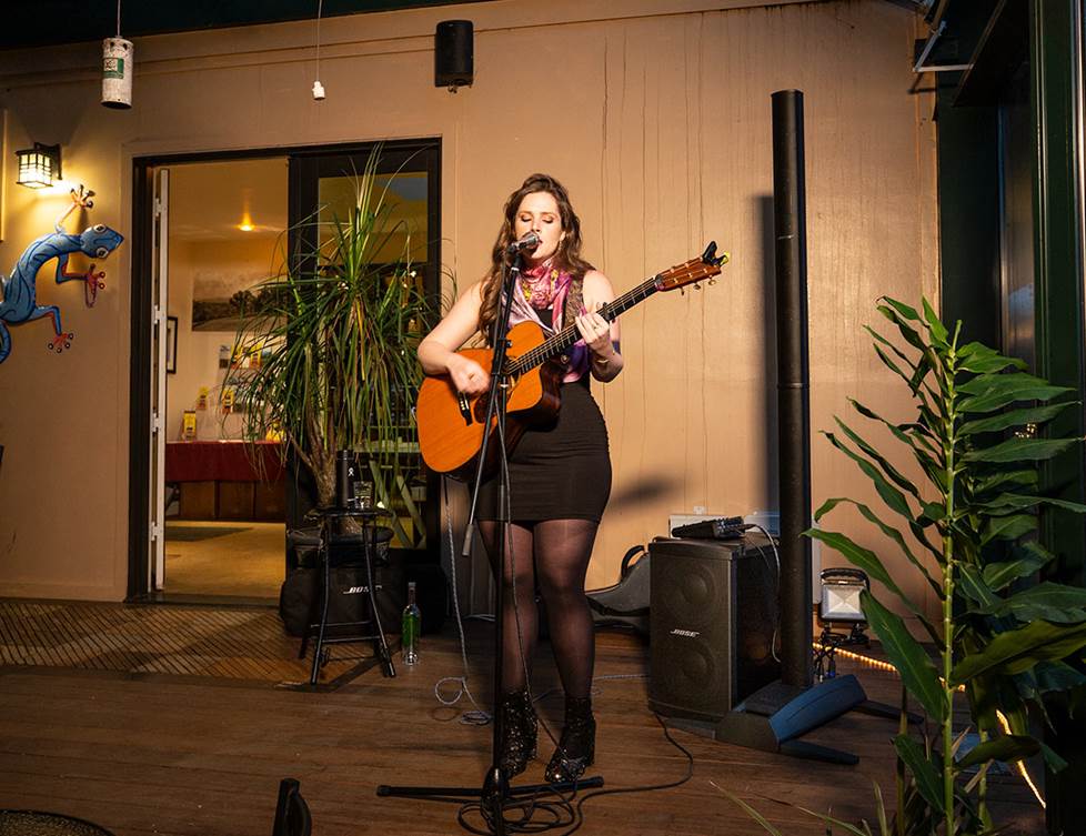 female singer-songwriter performing