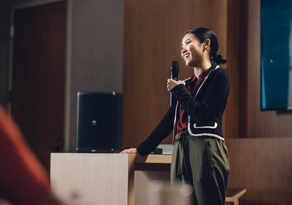 Public speaker holding wireless mic