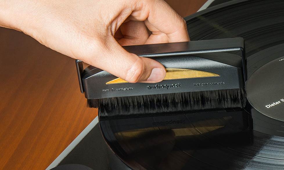 Hand cleaning a record a record brush.