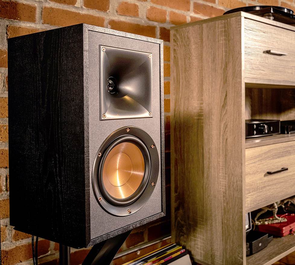 Klipsch speakers next to a cabinet