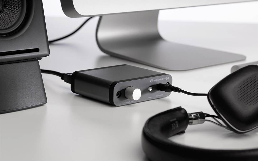 DAC plugged into desktop computer with headphones attached.