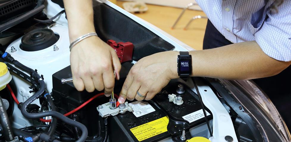 Attaching the power cable to the Subaru's battery.