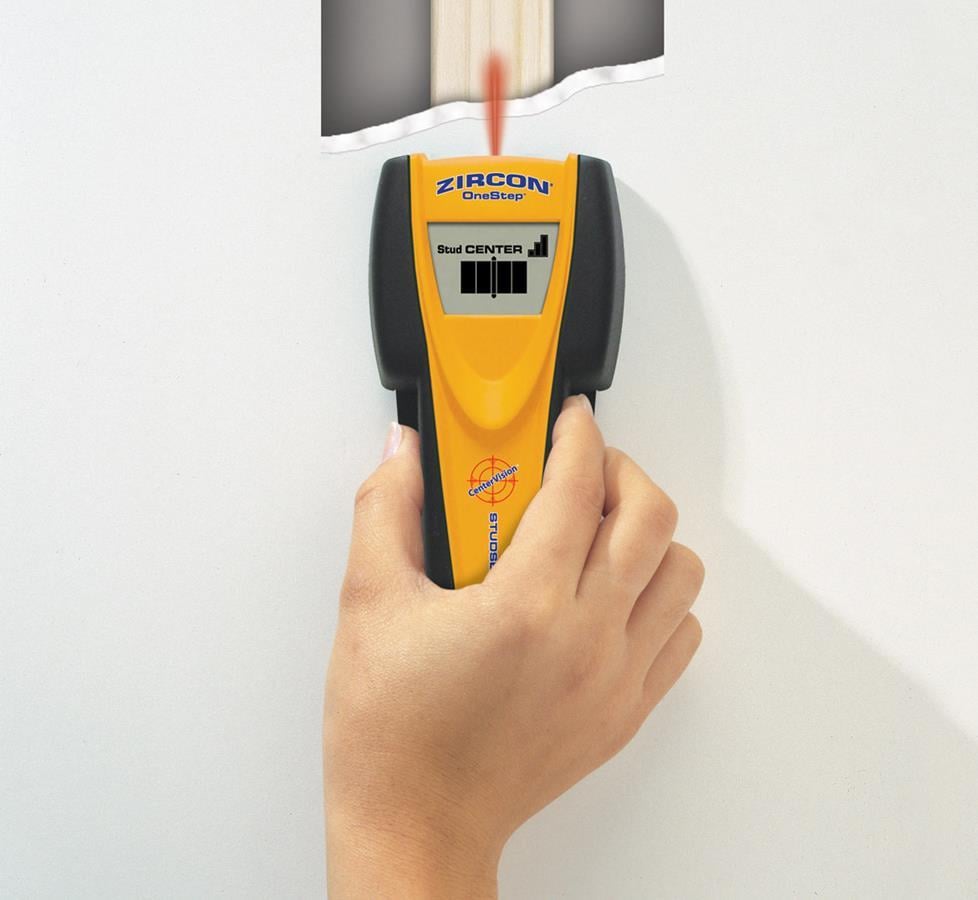 Photo of stud finder being used.