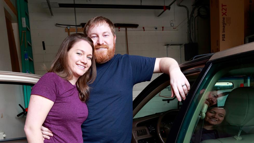 Kristy and CJ standing by their 1998 Toyota Camry