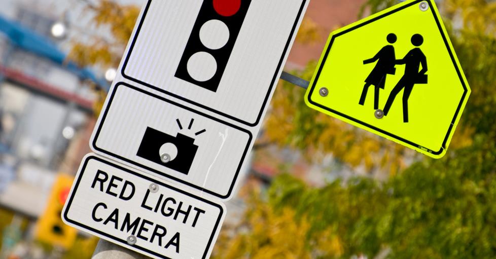 Red light camera sign on a street