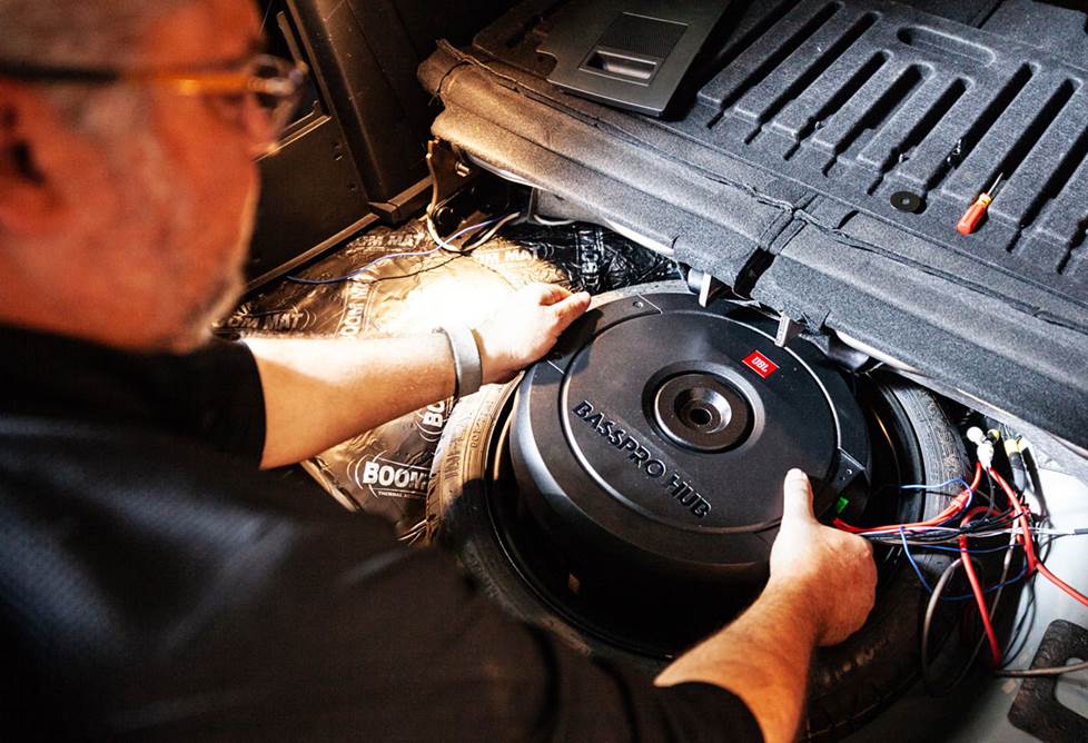 Installing his JBL BassPro Hub in the trunk of his car