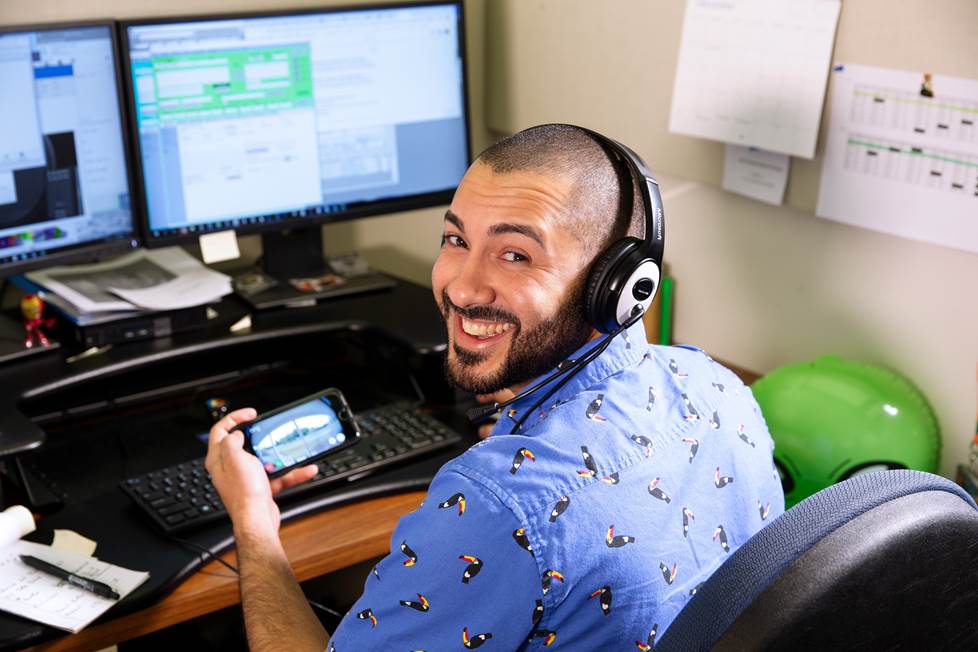 Carlos at his desk, helping customers online