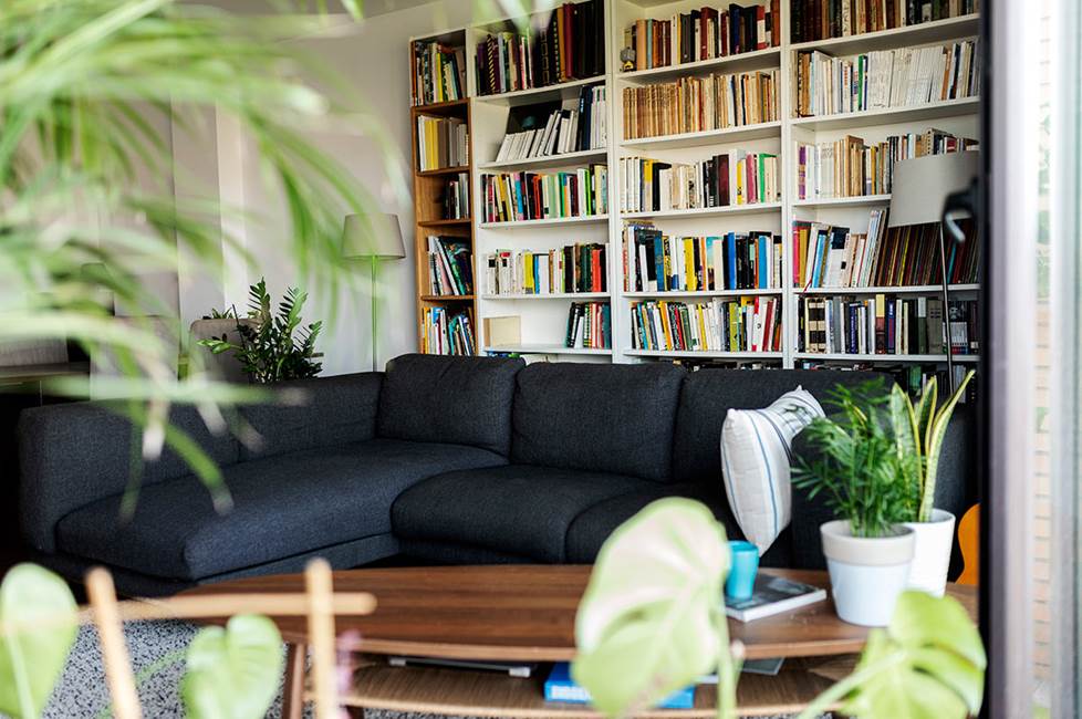 living room with bookcase behind couch