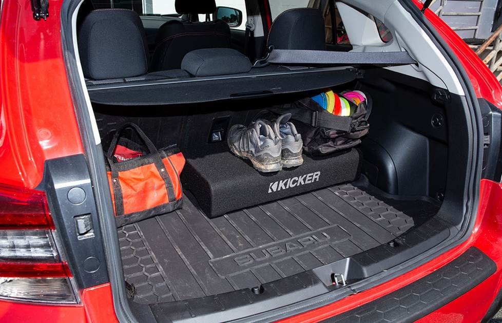 Subwoofer in the rear cargo are with luggage on top of it
