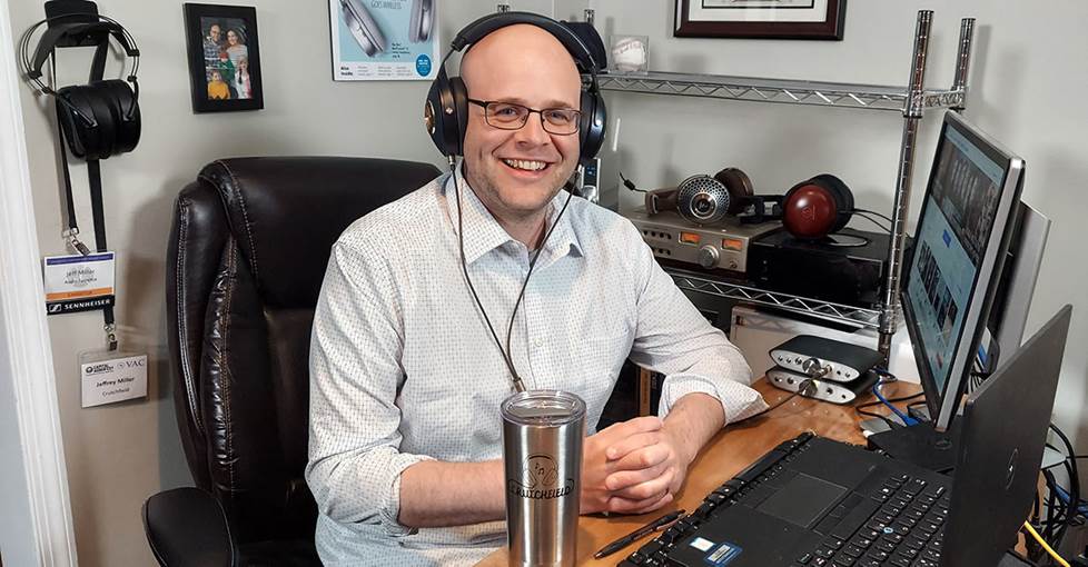 Man sitting at his desk smiling