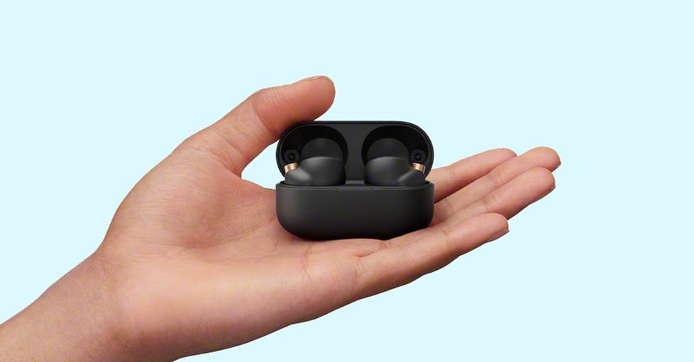 a hand holding Sony WF-1000XM4 earbuds
