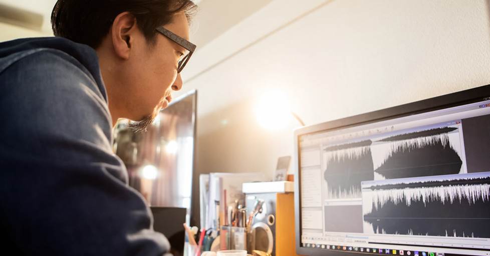 Men concentrating on a digital audio workstation screen