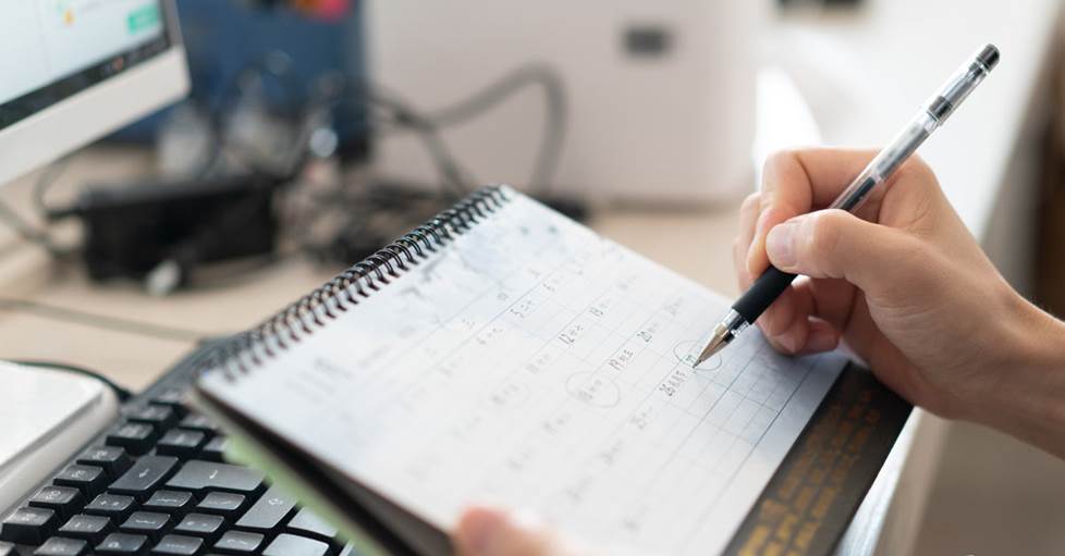 Person working on a paper calendar