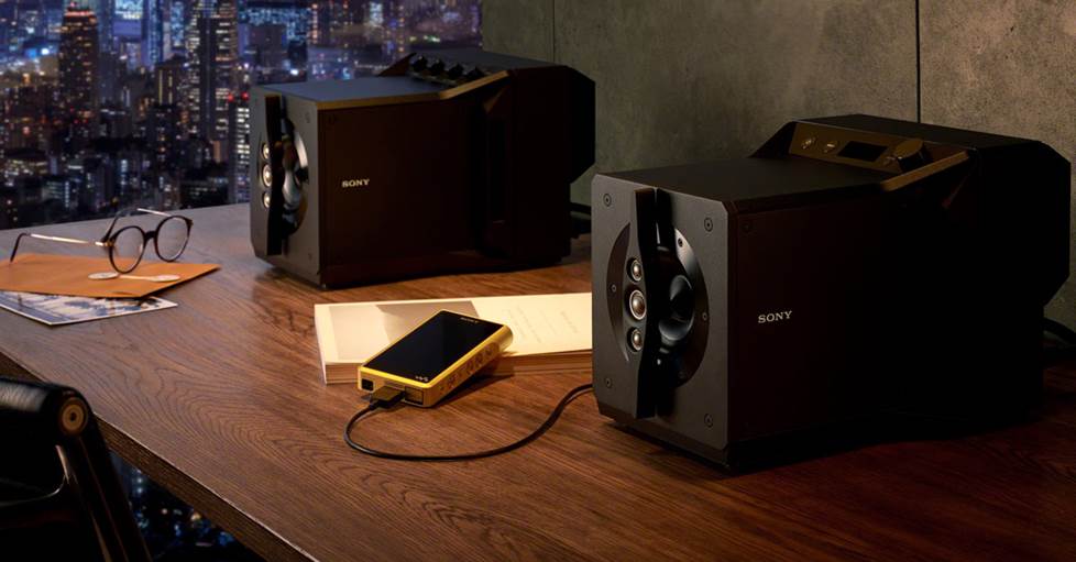 Sony Signature Series SA-Z1 Reference-quality desktop speakers on a desk, connected to a Sony Walkman High-resolution portable digital music player