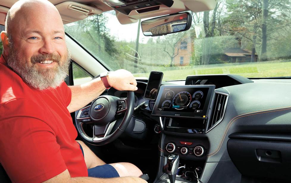 JR behind the wheel, with his dog riding shotgun