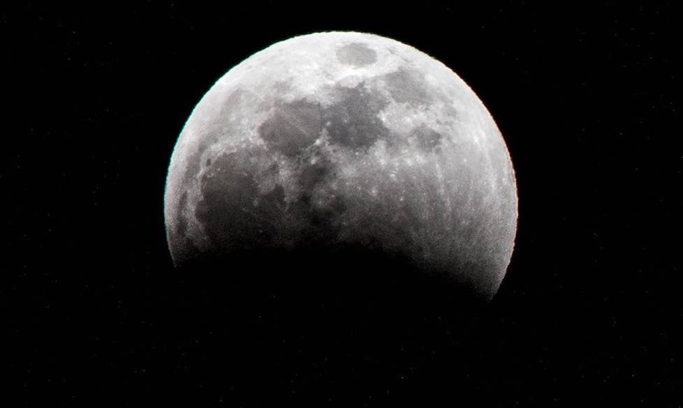 Night sky with moon through binoculars