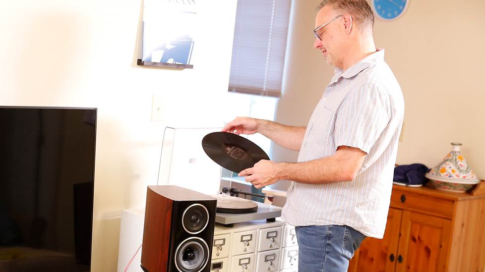 The author at home, putting on a vinyl record