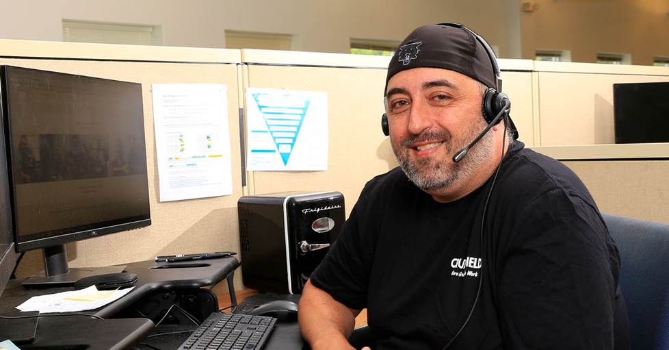 Friendly sales advisor sitting at a desk