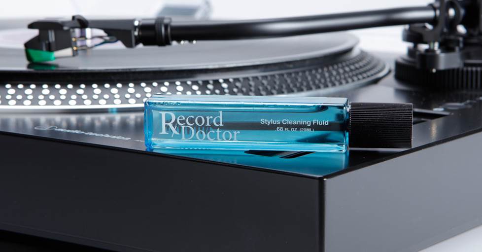 Record Doctor SCF Stylus cleaning fluid with brush sitting on the edge of a turntable