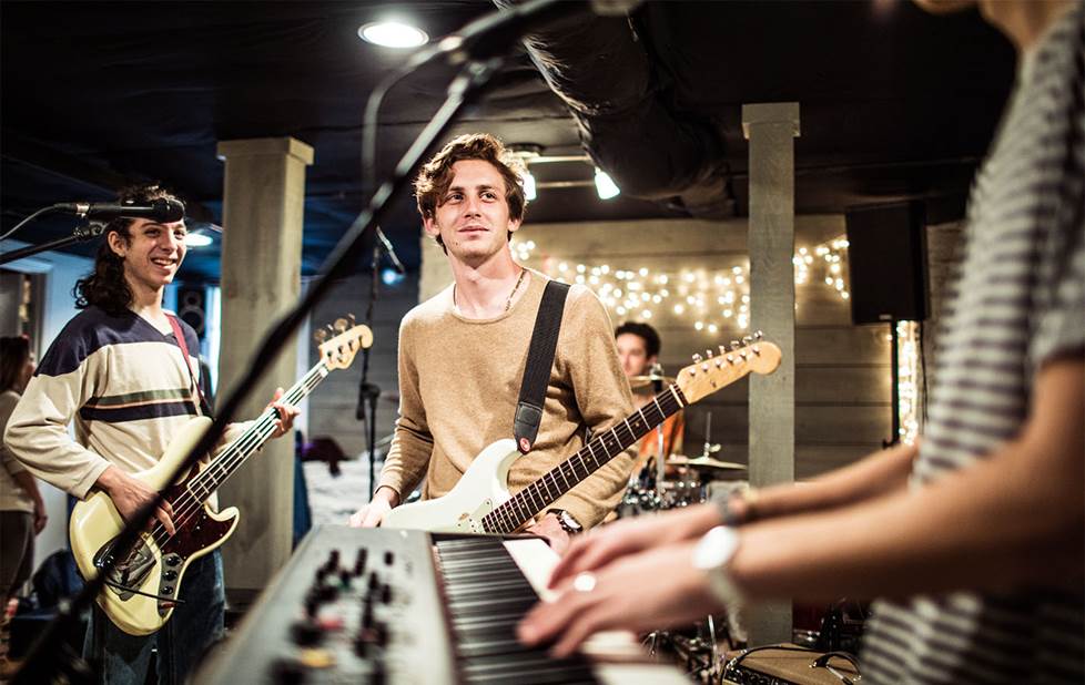 Young rock band practicing in the basement