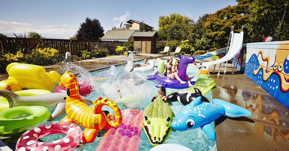 Image of a pool filled with colorful pool toys, with HDR