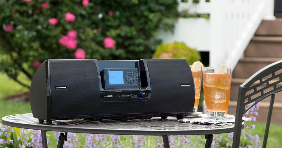 The SXM Onyx tuner with the speaker dock, outside on a table