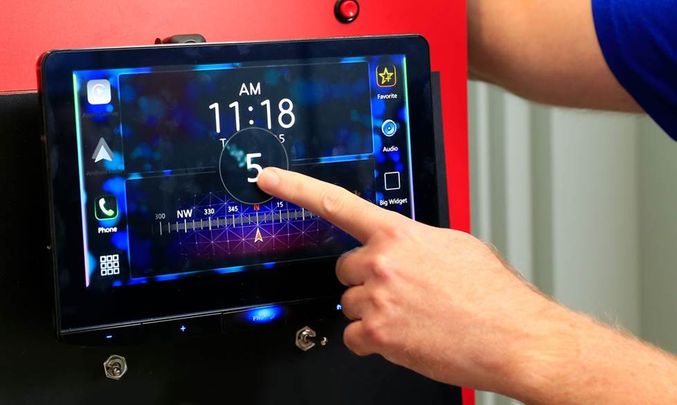Photo of a JVC receiver showing one of the touch-screen gesture controls as a hand swipes down with one finger.