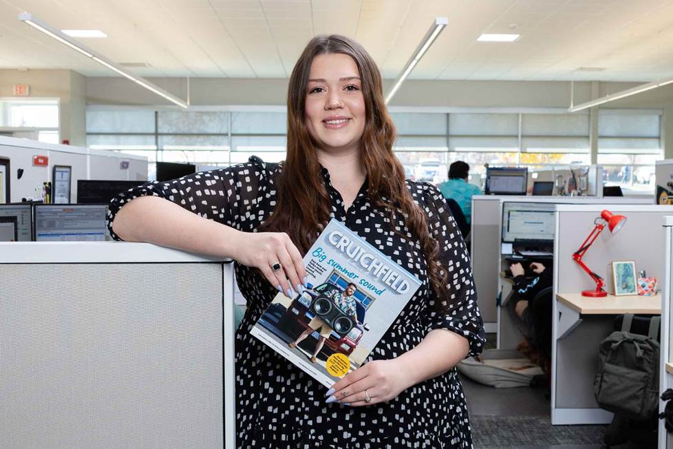 Advisor holding a Crutchfield catalog