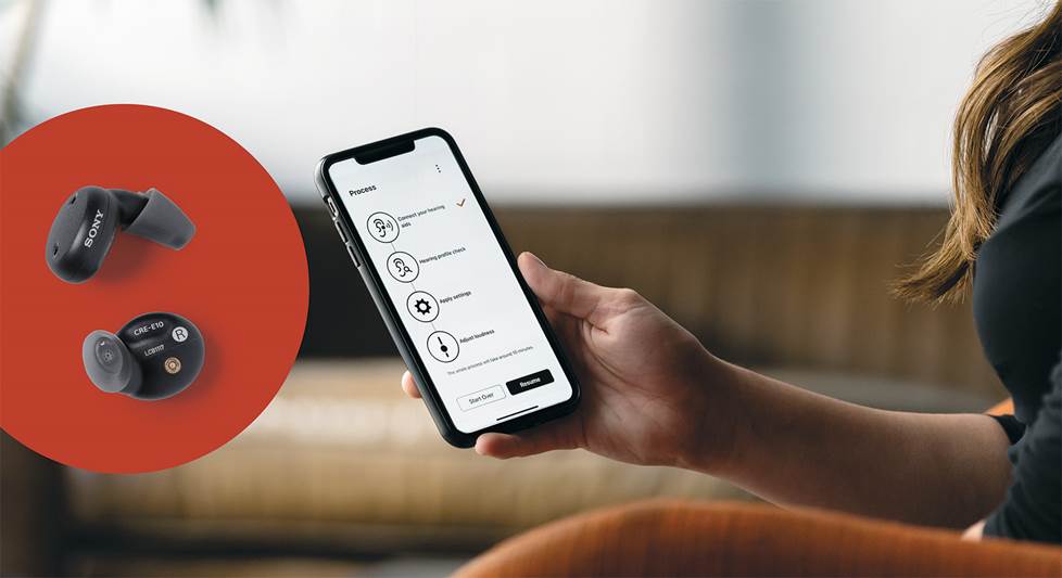 person using a hearing aid control app on their phone and a close up of Sony hearing aids on a red dot