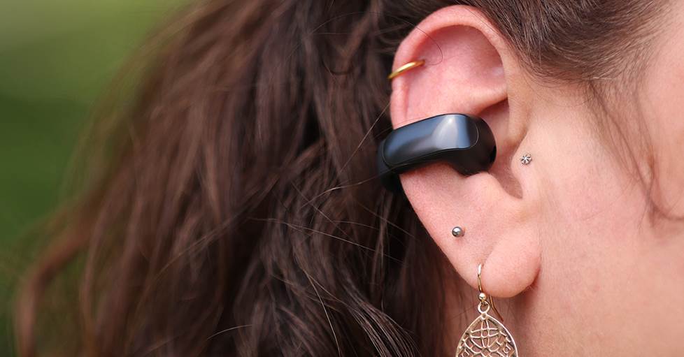 Bose Ultra Open earbuds shown in ear with tragus piercing