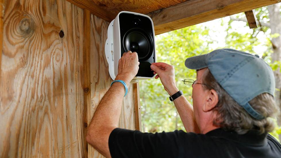 Norm installing Tara's treehouse Sonos system