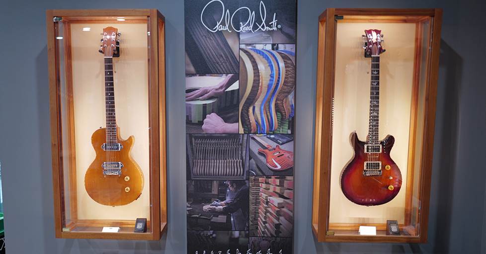 Iconic models displayed in lit window boxes in the PRS gift shop.