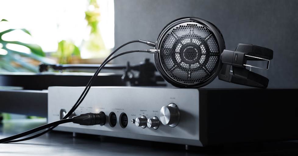 Audio-Technica ATH-ADX7000 sitting on top of a headphone amp