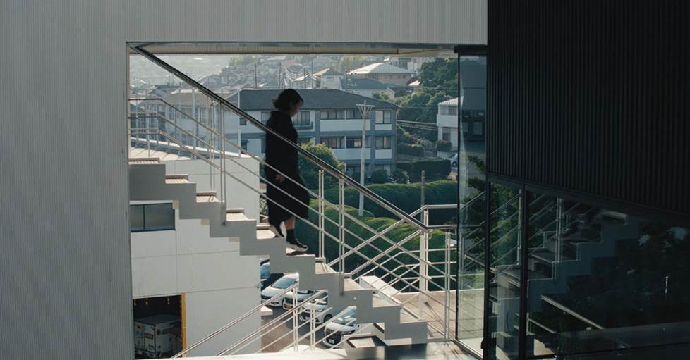 Shiwaku running down stairs in the office